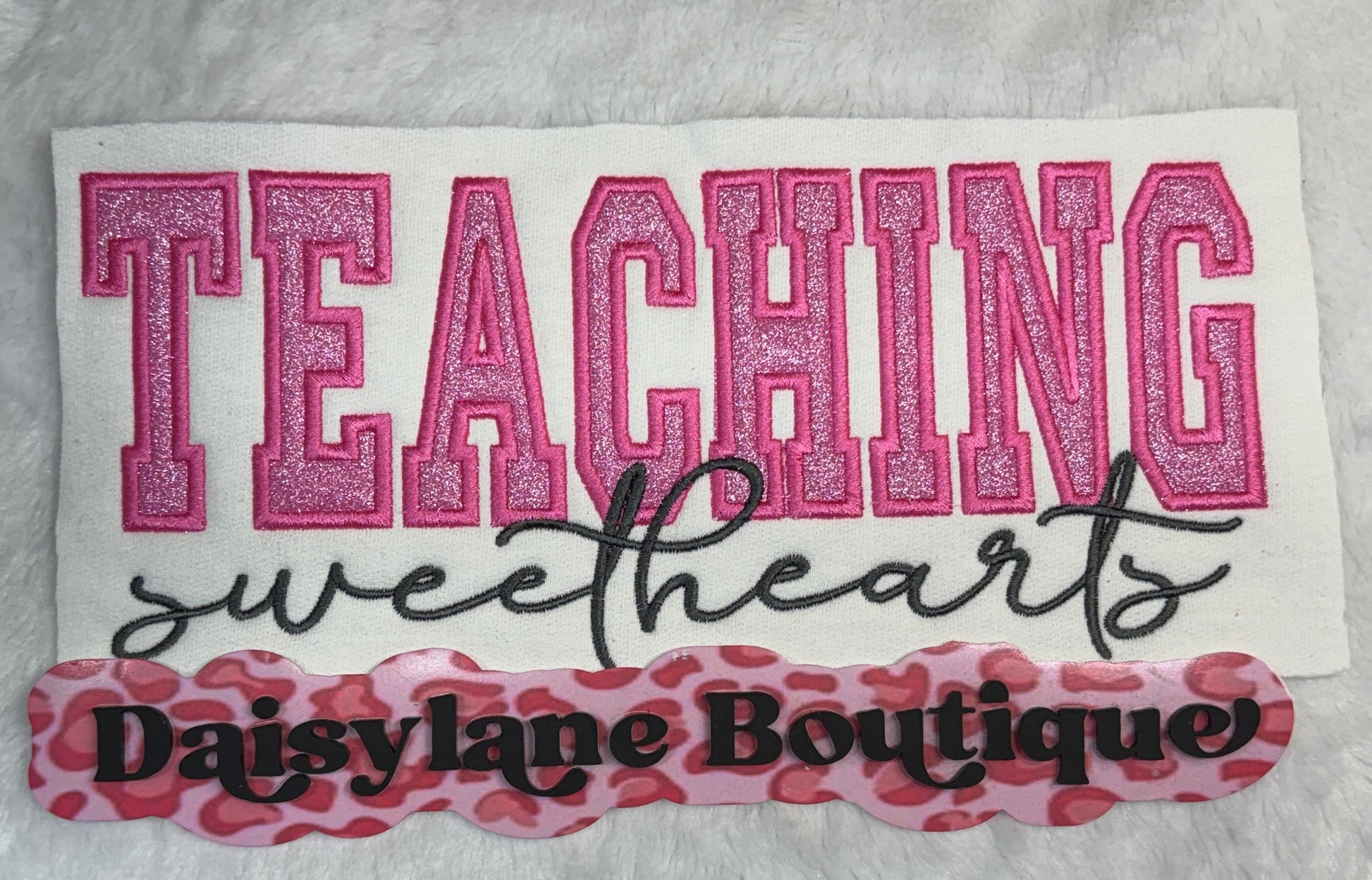 Embroidered patch with 'Teaching sweethearts' text and Daisylane Boutique branding on a white background.