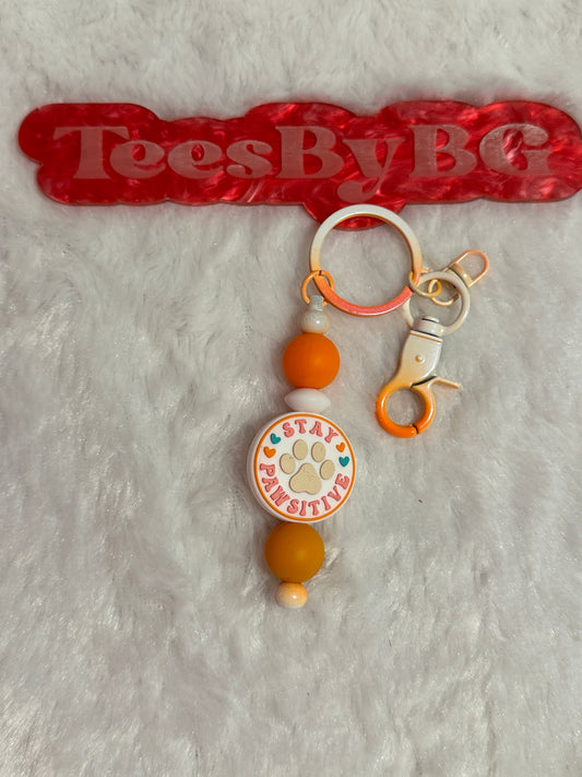 Stay Pawsitive on Tie Dye Orange Keychain